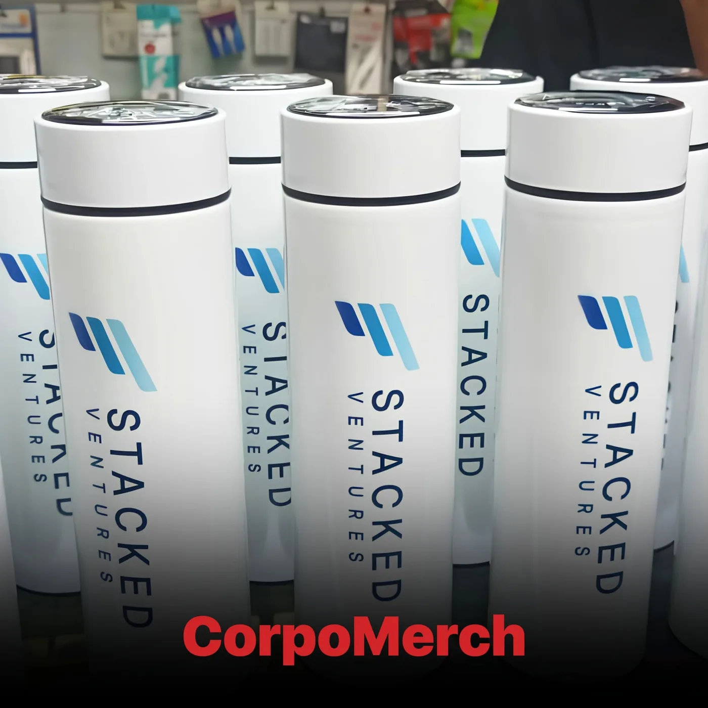 White Stacked Ventures branded thermal bottles lined up with the printed logo